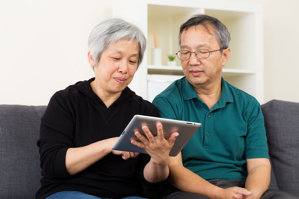 Asian old couple using tablet